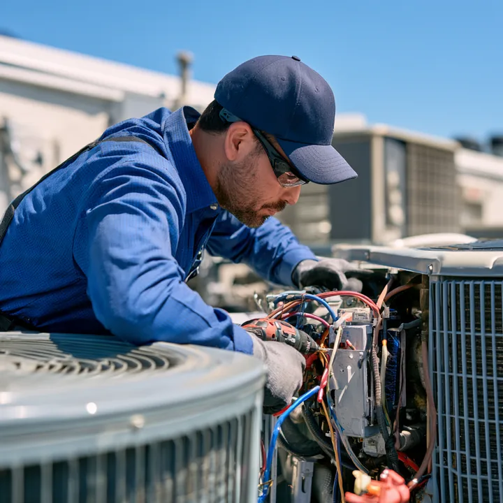 Technician testing HVAC electrical controls